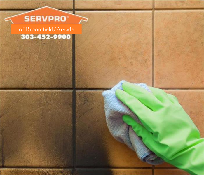 Cleaning and scrubbing soot damage off tiles in McKay Landing with SERPRO of Broomfield/Arvada logo
