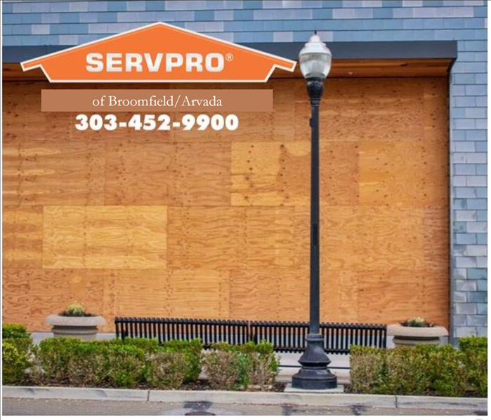 boarded up building in denver with SERVPRO of Broomfield/Arvada logo