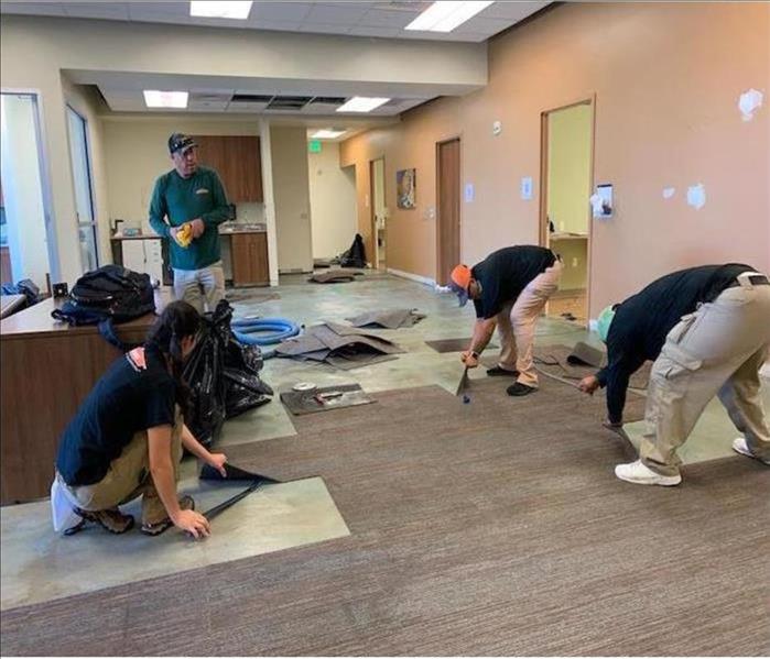 Crews cleaning up water damage in commercial office in Broomfield